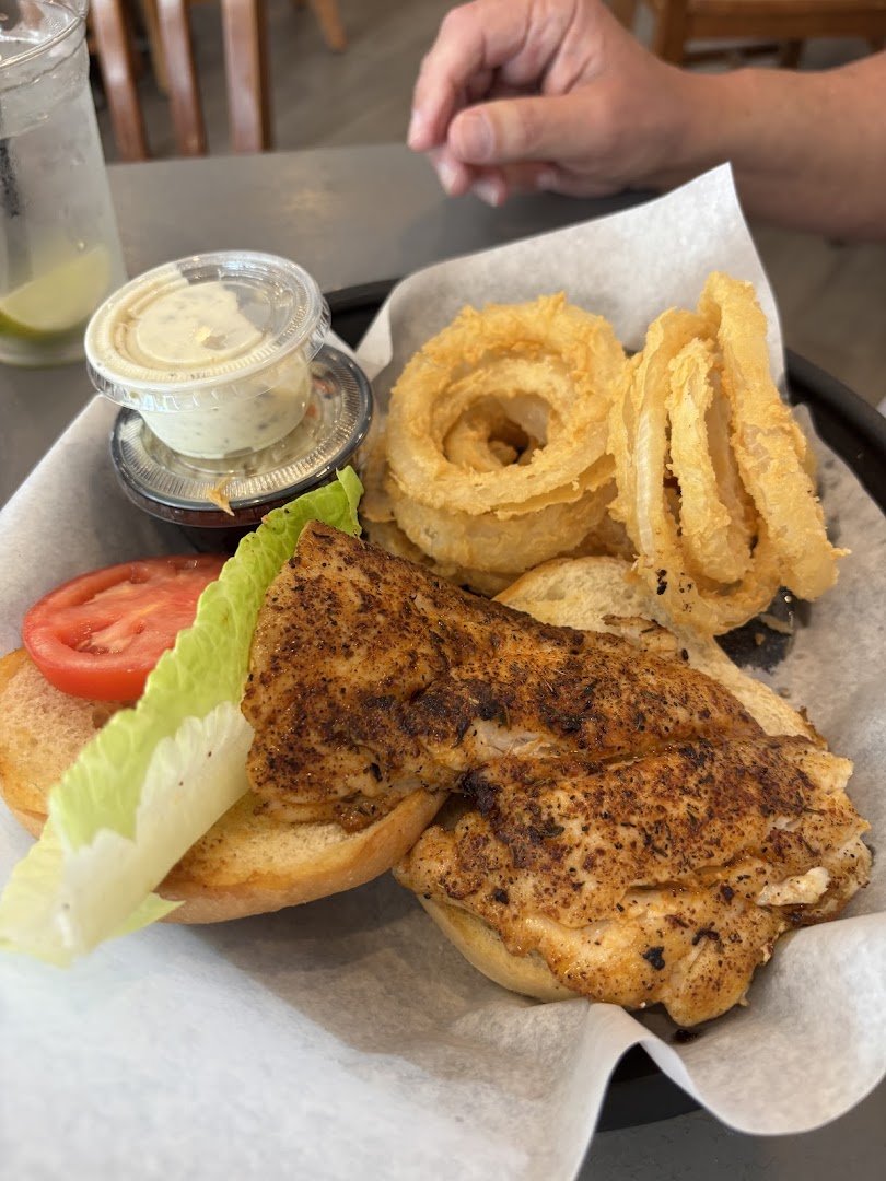 Fresh chowder and fried sides on white plates.
